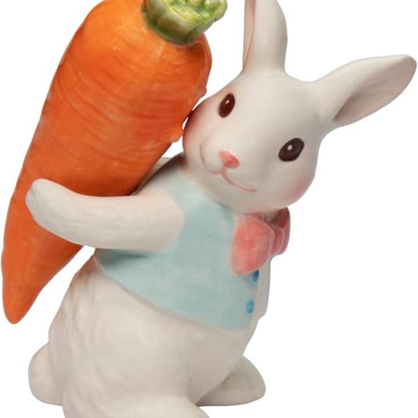 Ceramic rabbit figurine holding a large carrot