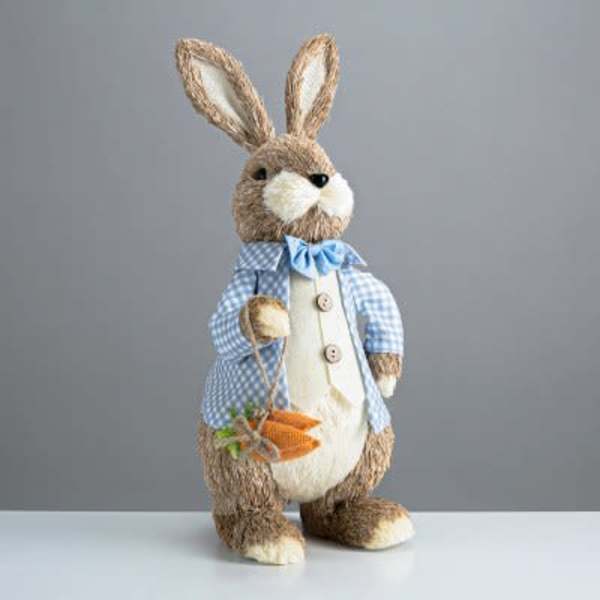 Decorative bunny figurine holding a small carrot basket