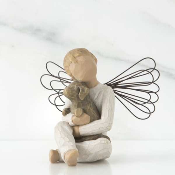 Decorative angel figurine holding a teddy bear