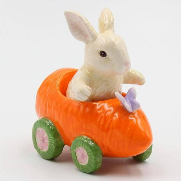 Ceramic bunny in an orange carrot-shaped cart with green wheels