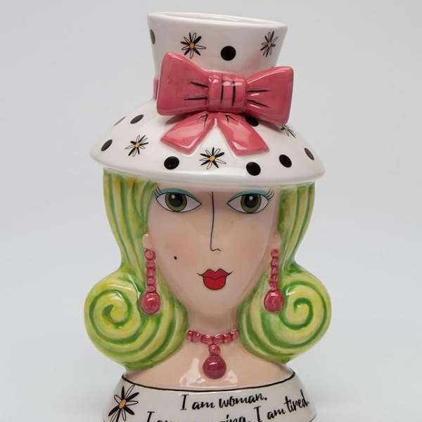 Decorative ceramic bust vase with a pink bow and painted face