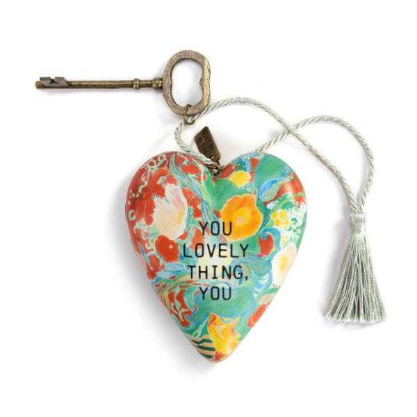 Heart-shaped decorative ornament with a key and tassel