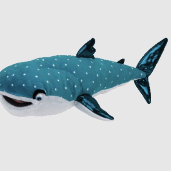 Blue whale plush toy with white spots on a plain background