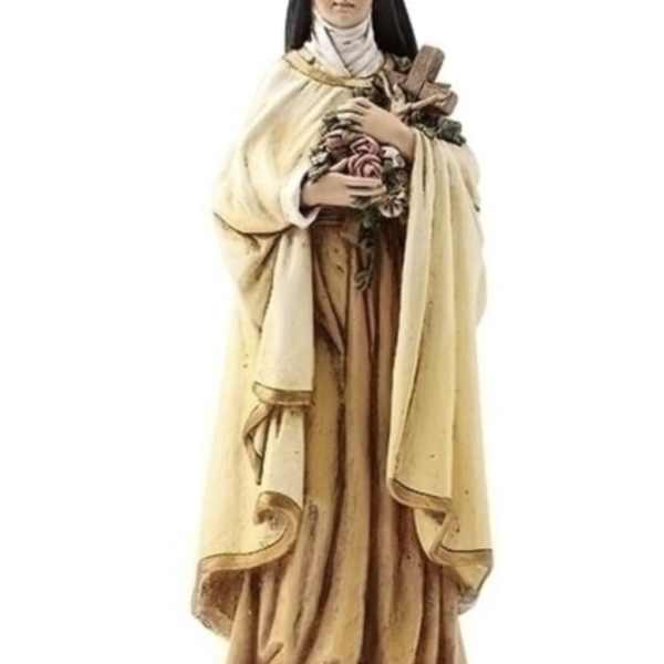Statue of a nun holding flowers and a cross