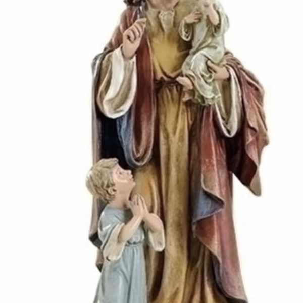 Religious statue of a man holding two children on a stone base