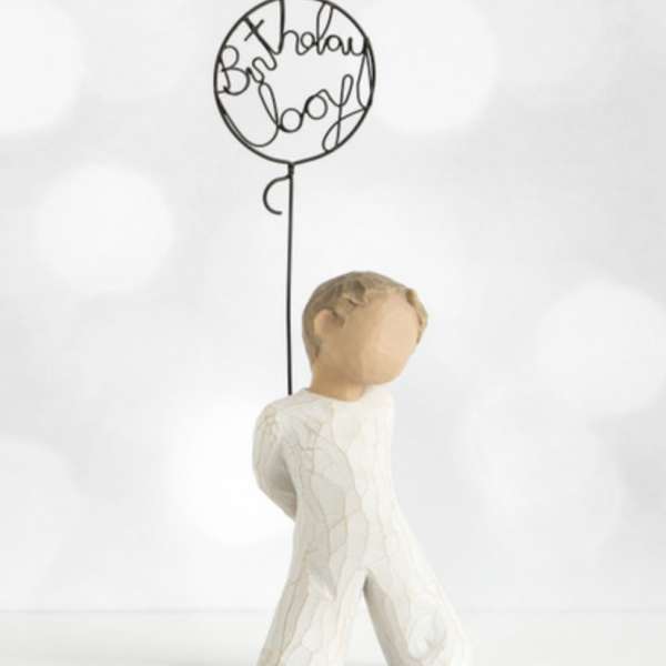 Small figurine holding a wire balloon with "Best Holiday Ever" text