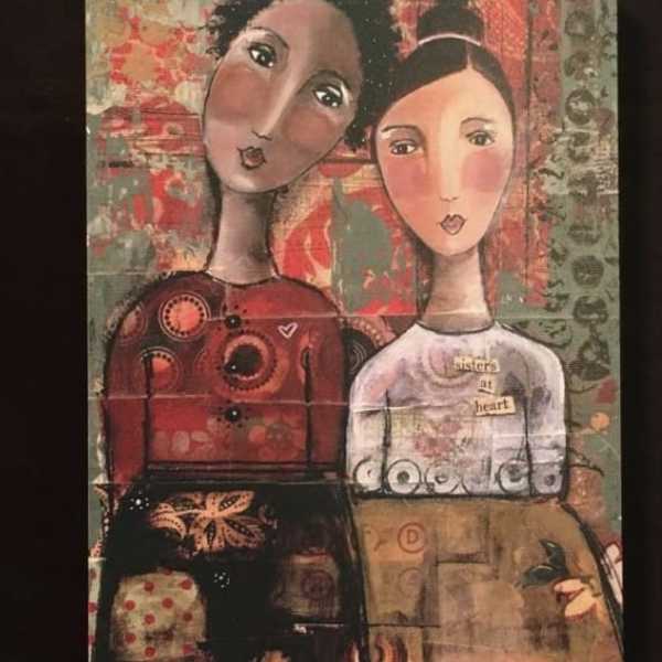 Decorative wall art showing two stylized girls with patterned clothing