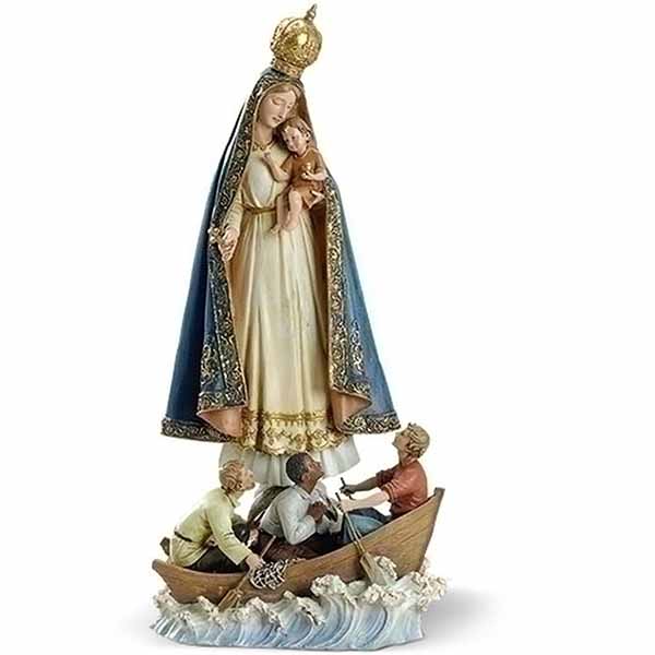 Religious statue of the Virgin Mary holding a child above a boat with figures below