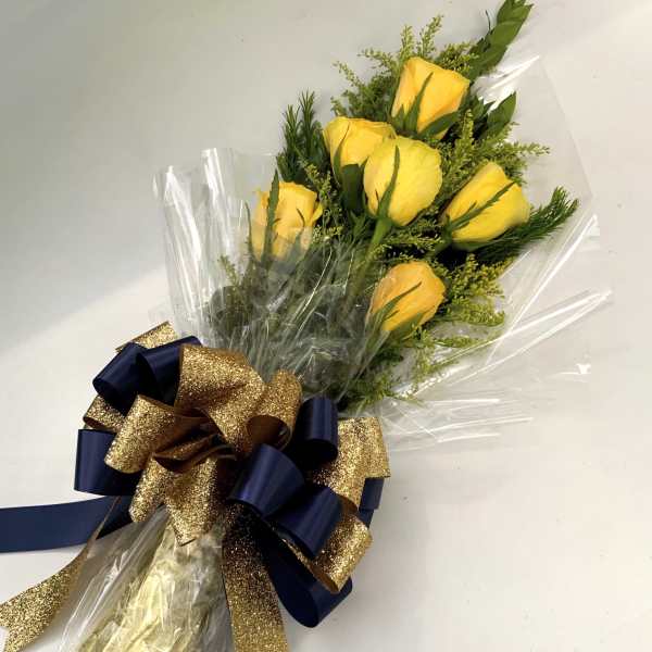 Bouquet of yellow roses wrapped in clear cellophane with a navy and gold bow