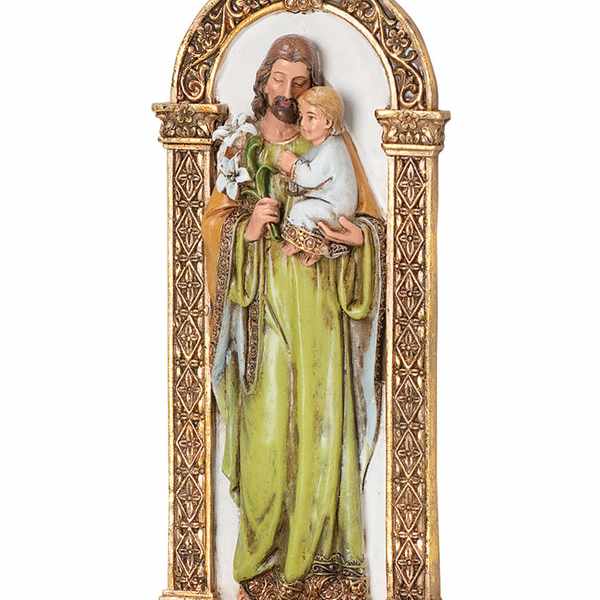 Religious figurine of a saint holding a child in an ornate gold frame