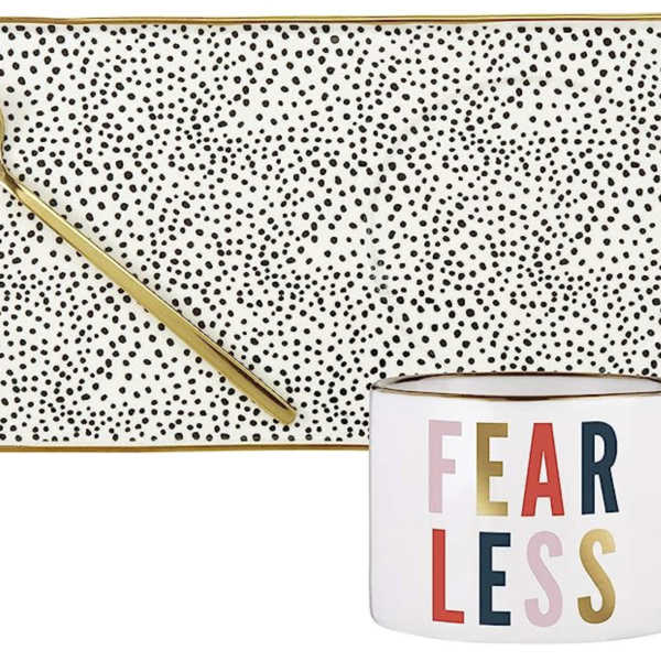 Patterned tray with gold spoon and a mug reading FEARLESS