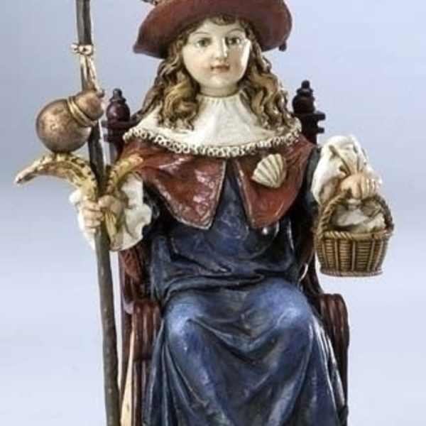 Decorative figurine of a seated girl holding a staff and basket