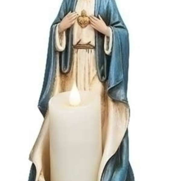 Statue of the Virgin Mary with a lit candle in front