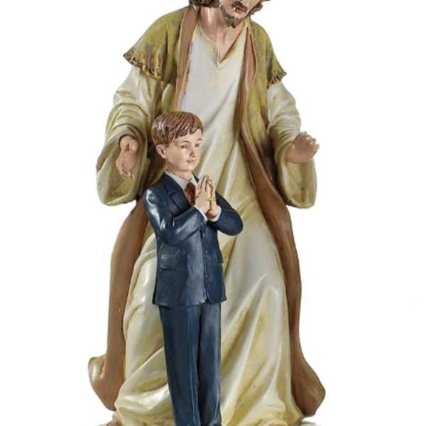 Religious figurine of Jesus standing behind a praying boy on a white base