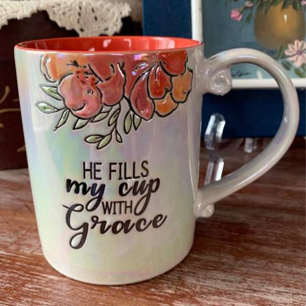Ceramic mug with floral design and the words "He fills my cup with grace"