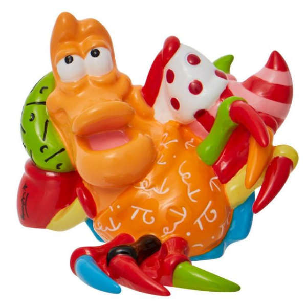 Colorful cartoon figurine with a reclining orange character and striped candy shapes
