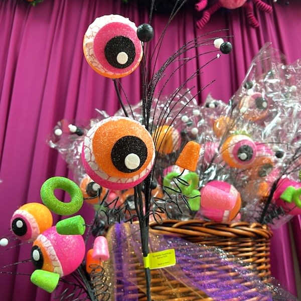 Basket of colorful candy eyeball decorations with black wire stems
