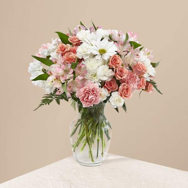 Pink and white mixed bouquet in a clear glass vase