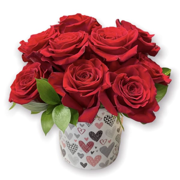Red roses arranged in a heart-patterned gift box