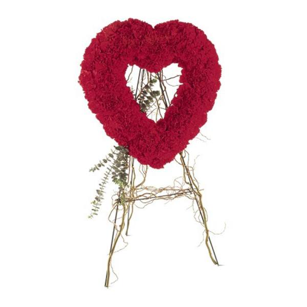 Tall standing red heart-shaped floral wreath on a rustic twig easel
