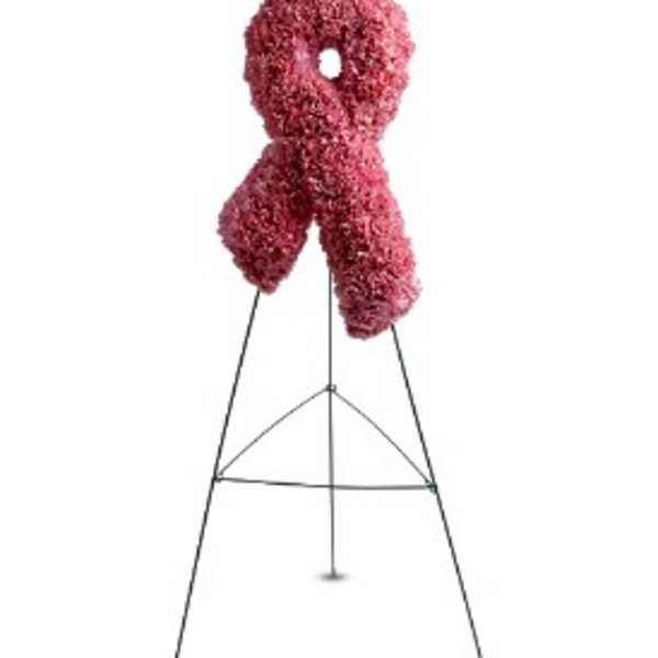 Tall pink floral awareness ribbon displayed on a metal easel stand