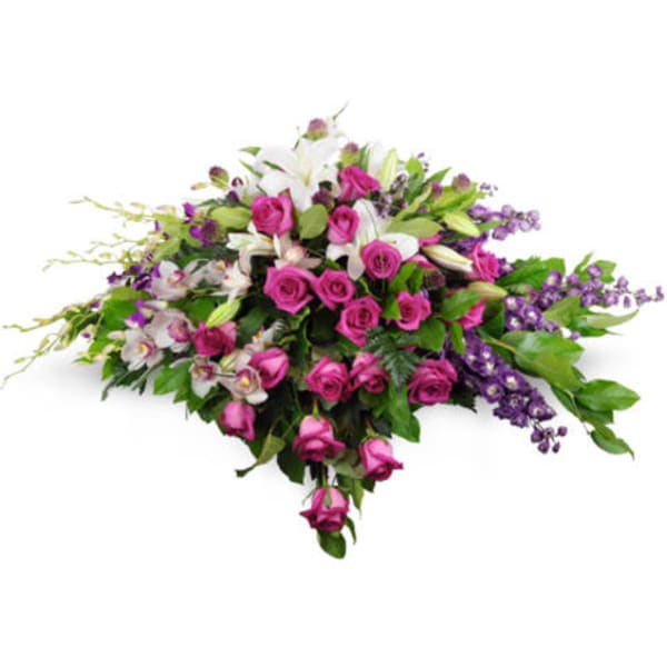 Pink roses and white lilies in a low, sprawling arrangement