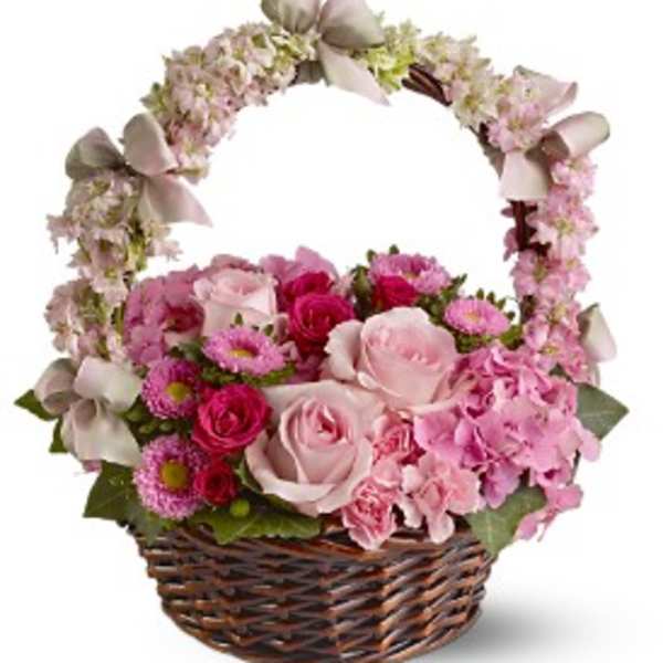 Pink rose and mixed flower basket with floral-covered handle and satin bows