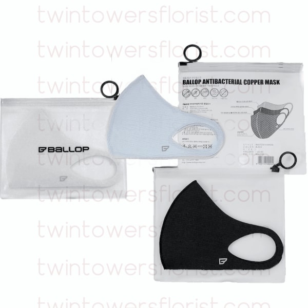 Three packaged face masks in white, light blue, and black