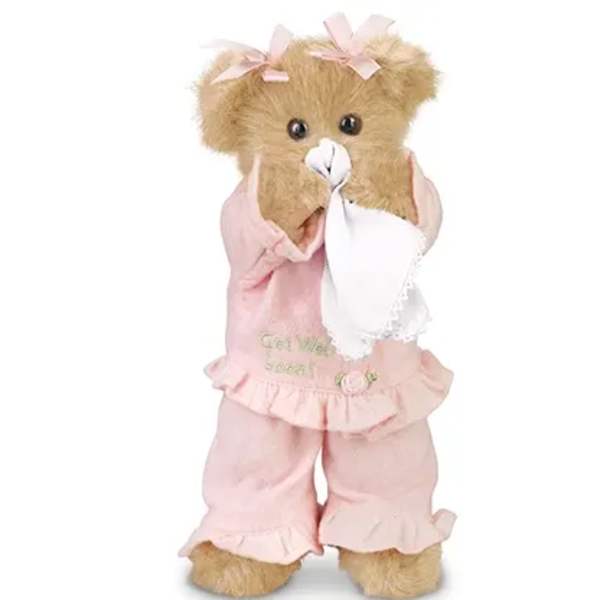 Teddy bear in pink pajamas holding a white cloth