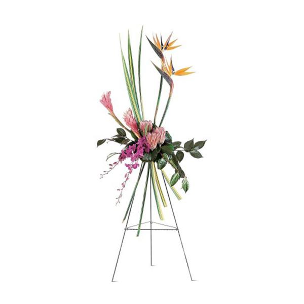 Tall tropical standing spray with orange birds of paradise and pink blooms on a metal easel