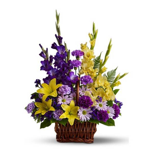 Basket arrangement of purple and yellow flowers including lilies, daisies, and carnations