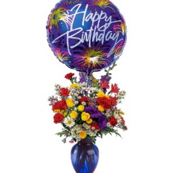 Birthday balloon above a colorful mixed flower arrangement in a blue vase