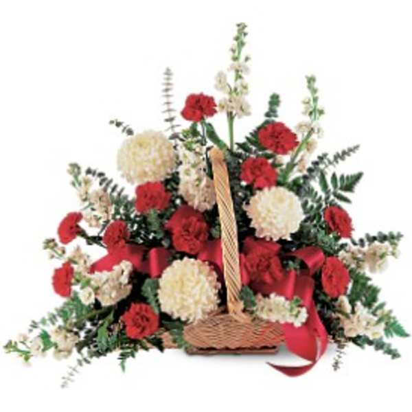 Basket arrangement of red and white flowers with a red ribbon