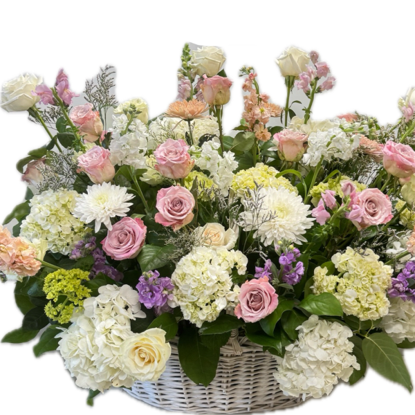 Large pastel flower basket with roses, hydrangeas, and white blooms