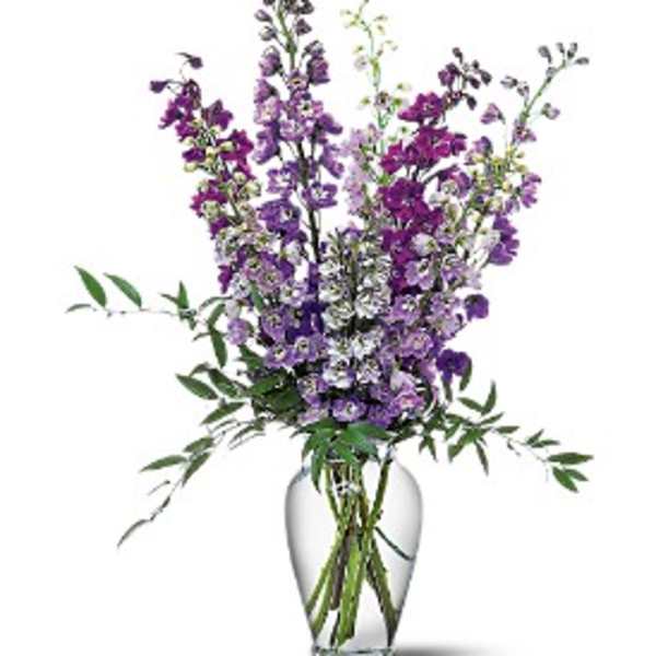 Purple mixed flowers in a clear glass vase
