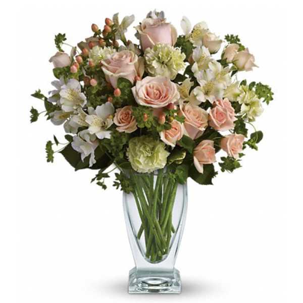 Pink roses and white alstroemeria in a clear glass vase
