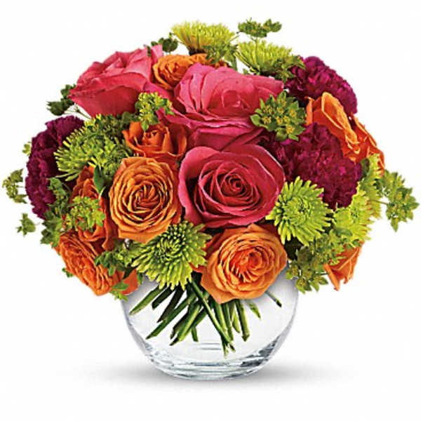 Bouquet of pink and orange roses in a clear glass vase