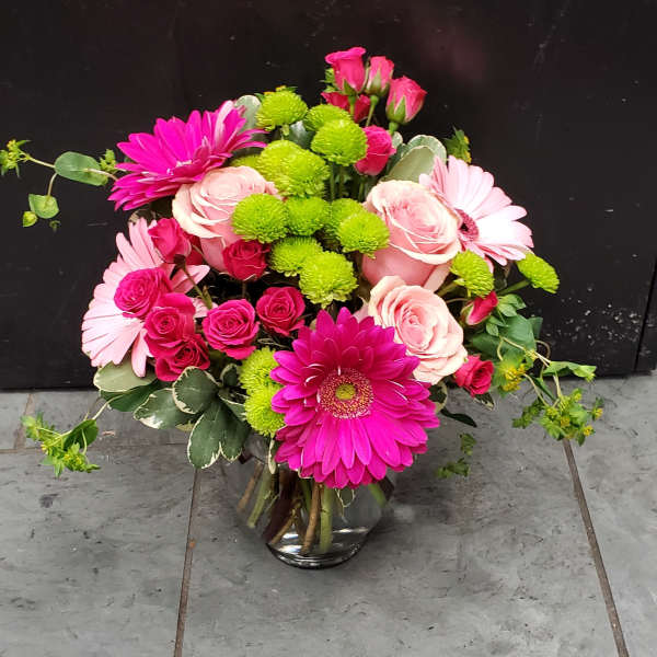 Pink and green mixed bouquet in a glass vase