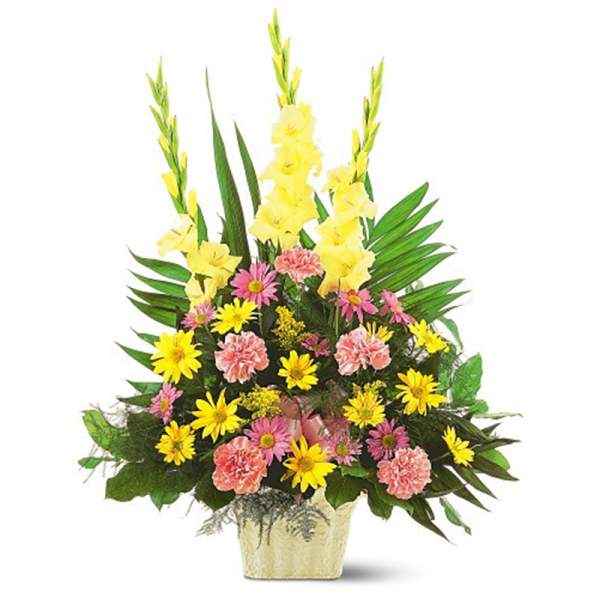 Tall yellow and pink mixed flower arrangement with gladiolus and daisies in a cream container