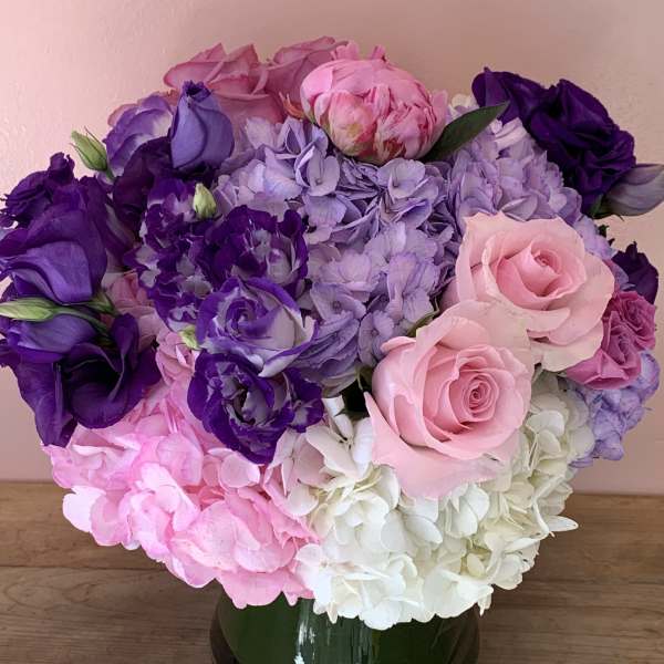 Pink, purple, and white flower bouquet in a glass vase