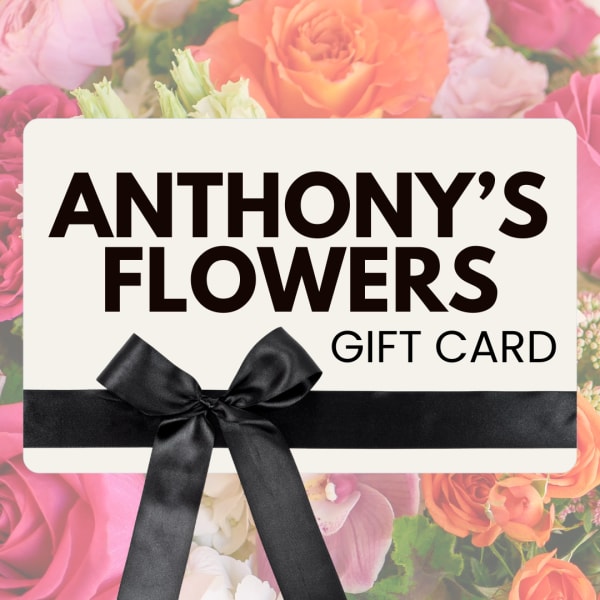 Gift card with a black ribbon over a floral background