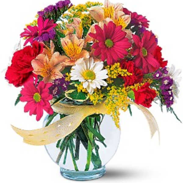 Colorful mixed bouquet in a clear glass vase with a ribbon