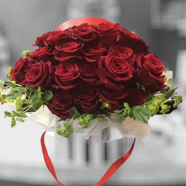 Bouquet of red roses with green filler and a red ribbon