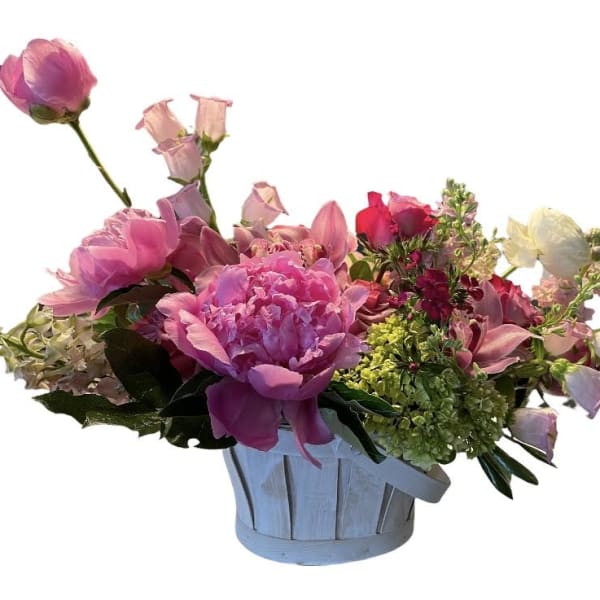 Pink and white mixed flower arrangement in a light blue basket