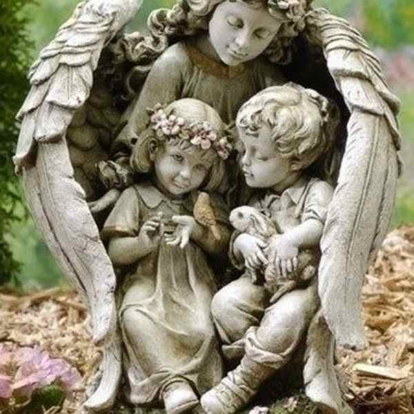 Stone angel statue of three children with flowers and a rabbit