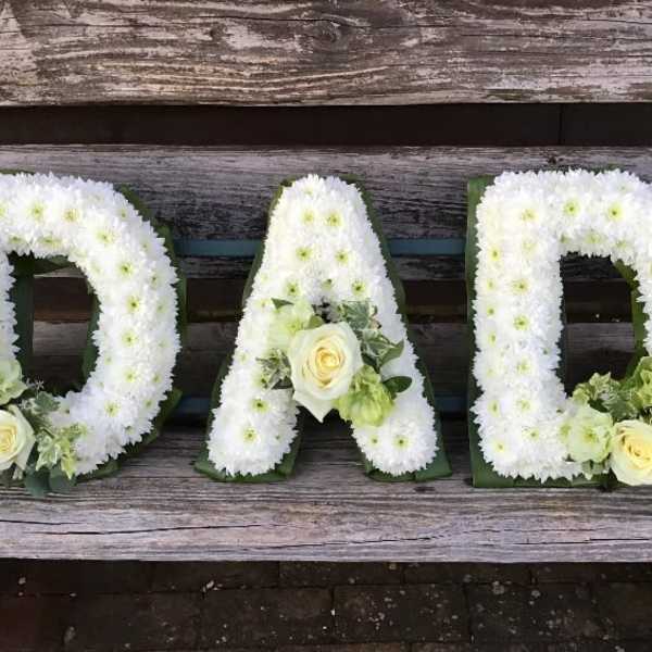 White floral letters DAD with pale yellow roses