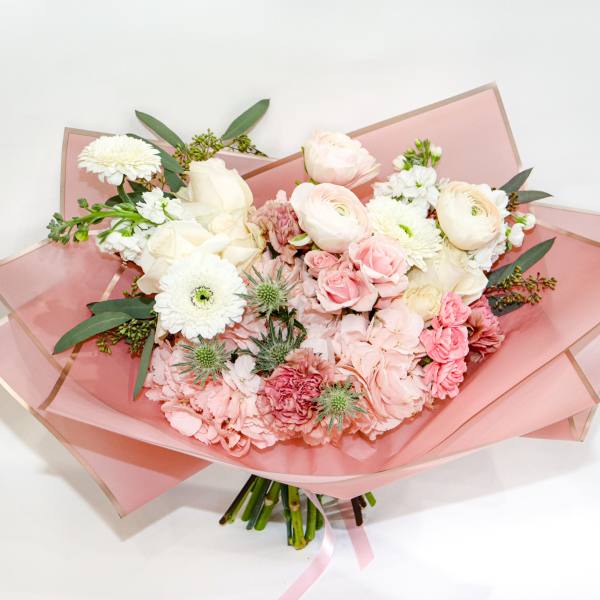 Pink and white mixed bouquet wrapped in translucent pink paper