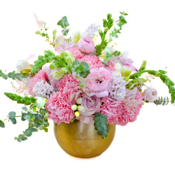 Pink and white floral arrangement in a gold vase
