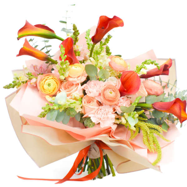 Bouquet of orange calla lilies and peach roses wrapped in pink paper