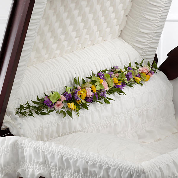 Floral spray of pink, purple, and yellow blooms on a white chair